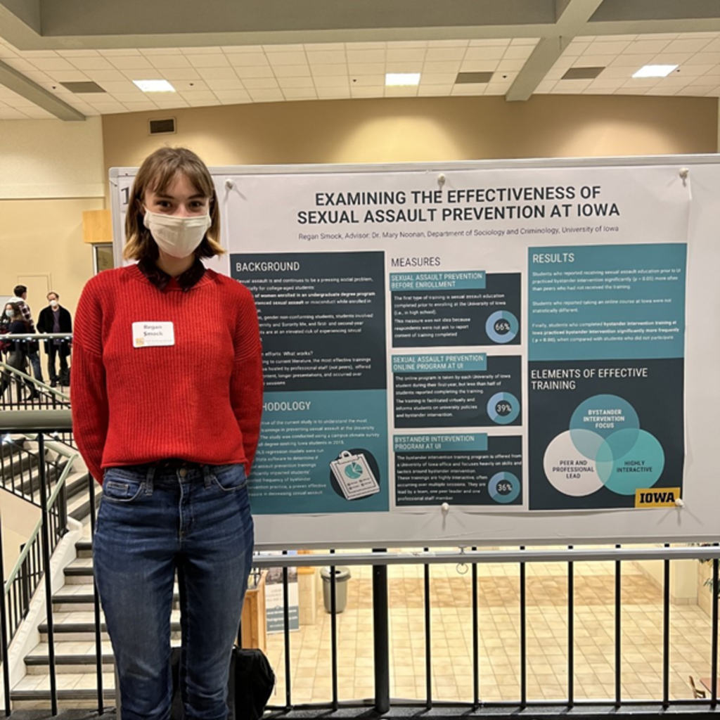 Regan Smock standing in front of research poster