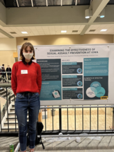 Regan Smock standing in front of research poster