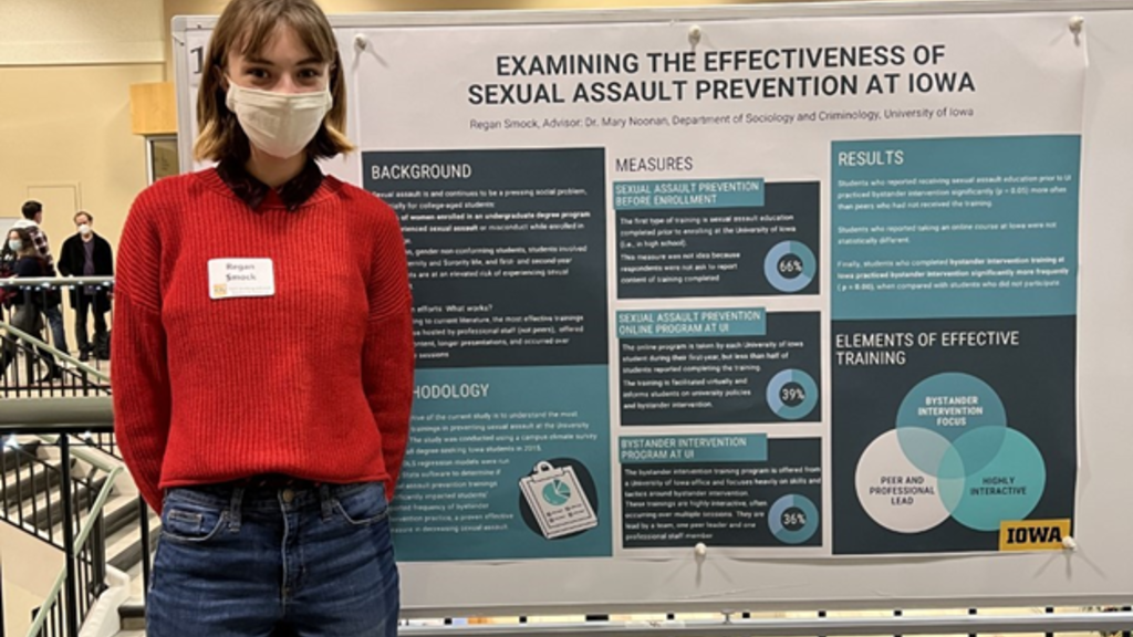 Regan Smock standing in front of research poster