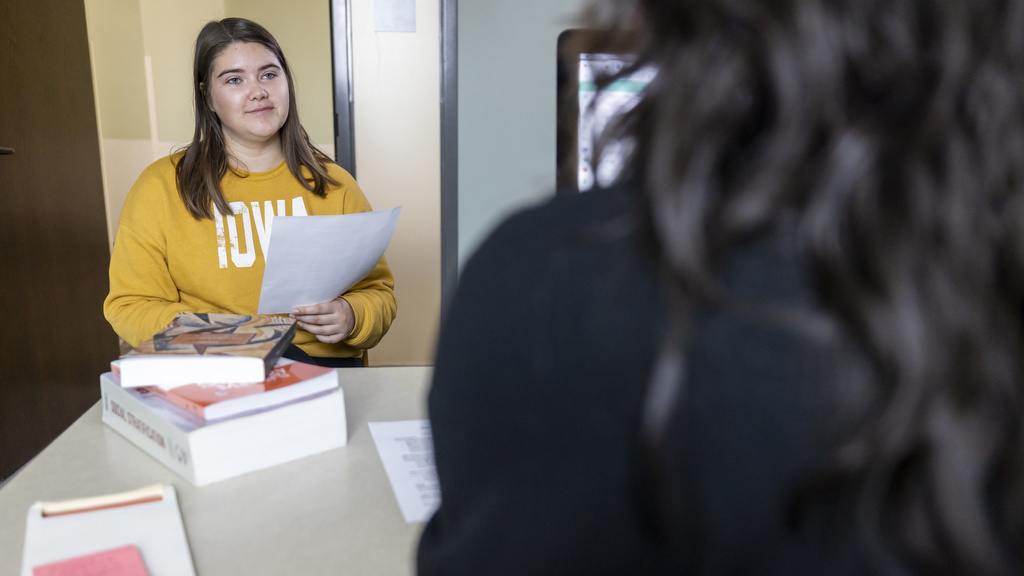 Student with professor discussing a paper